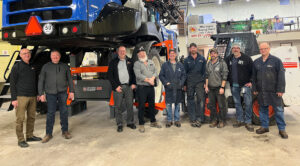 Old's College team in front of TireGrabber & Jack